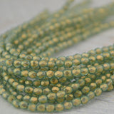 HALO HEAVENS Faceted Round Beads /Firepolished /3mm Czech Glass Beads Qty 50 Fire Polish Facet Beads Transparent Green with Gold Finish